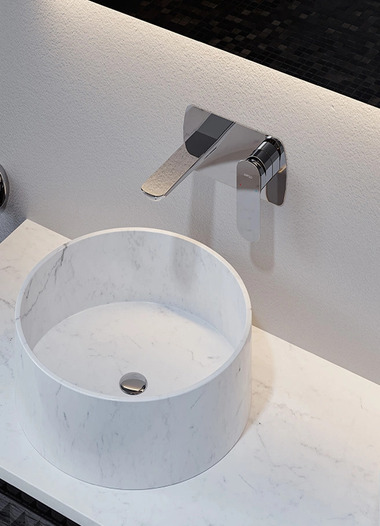 Chrome-plated wall-mounted single-handle basin faucet paired with an above-counter basin